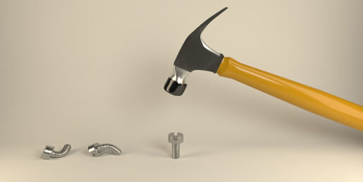 Hammer about to hit a nail.