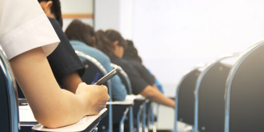 A snapshot of various students writing at their desks.