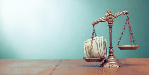 Balancing scale with a stack of bills.