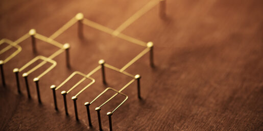 Pins on a cork board show a hierarchy branching downward.