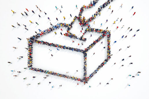 Crowds of people are seen from afar in the shape of a ballot box.