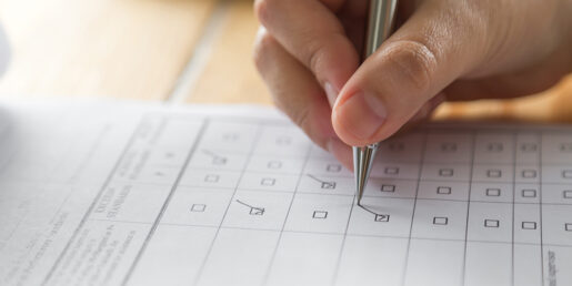Pen being used to check off boxes on a piece of paper.