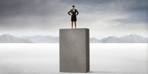 Woman standing on top of a large rock.