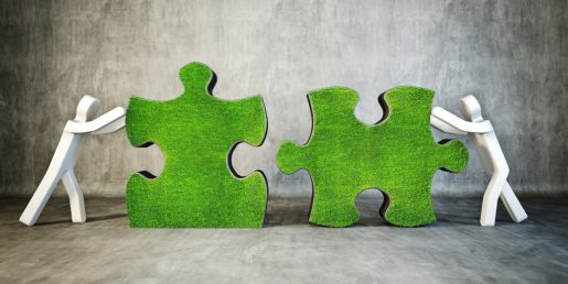 Two puzzle pieces being pushed together by cartoon figures.