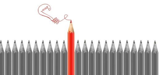 An assortment of pencils side by side with one large red one out of line with the others.