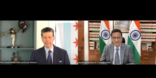 A side by side gallery view of zoom: on the left, a man in a suit with a flag and a gold statue behind him with the name Professor David B. Wilkins (Harvard Law School) in the bottom; on the right, an Indian man wearing a suit in front of two Indian flags smiles, with the name CJI D Y Chandrachud in the bottom corner.