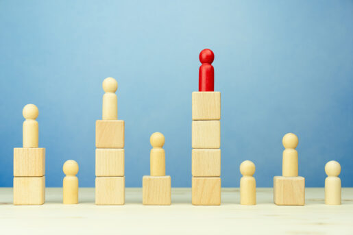 Different pawns sit on top of differing stacks of blocks, with one taller than the others in red.