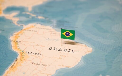 A map of Brazil with the Brazilian flag on a pin.