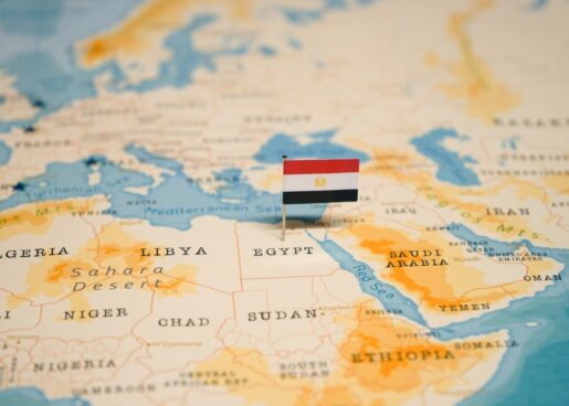 A map of Egypt with the Egyptian flag rising out of it.