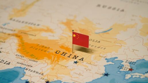 Map of China with the Chinese flag pinned to it.